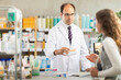 © JackF - Experienced male pharmacist helping girl choose medicines in a pharmacy