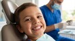 © BENNY - Happy young boy smiling in dental chair with dentist in background.