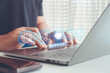 © MUNTHITA - Customer service and technical support technology concept. Person hand using laptop with digital icon, ai assistance, chat, email, call center, global service for online business, IT solution.