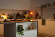 © Pixel-Shot - Interior of kitchen with counters, utensils and glowing lamps in evening