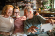 © Geber86 - Grandparents taking a selfie with grandchild at home