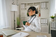 © Miljan Živković - Asian female doctor thinking during a coffee break