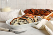 © Pixel-Shot - Plate with pieces of sweet poppy seed roll on white table
