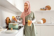 © Pixel-Shot - Beautiful young Muslim woman in hijab boiling pasta in kitchen