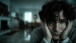 © Dmitriy - Lonely man sitting alone at night apartment in sadness and reflection with moody urban light and quiet cinematic atmosphere.
