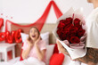 © Pixel-Shot - Young man with roses for his girlfriend in bedroom on Valentine's Day, closeup