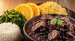 © Dwey - A close-up of a bowl of feijoada with all the accompaniments white rice, finely sliced kale, orange slices, and farofa, a macro shot highlighting the diverse textures.