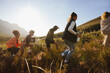 © Jacob Lund - Group hiking through a sunny field