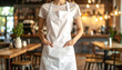 © miracle - A person wearing blank white apron in a cafe.