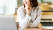 © Trickster* - ノートPCで作業する笑顔のビジネスウーマン・計画イメージ, Smiling Businesswoman Working on Laptop with Notes