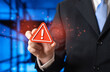 © Andrii Yalanskyi - A businessman warns of something unacceptable by holding a sign of attention. Red flags for a business leader. A serious breakdown, accident, or error. Crisis alert, risk prevention
