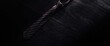© MetaPixel - Black wooden table with a striped necktie from a top perspective