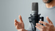 © Bonsales - Podcaster engaging audience, speaking into professional condenser microphone, gesturing hands for clear communication