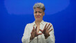 © Krakenimages.com - Woman holds palms forward in blue studio setting showing refusal posture with clear hands up stop gesture; disgust.
