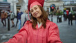 © Krakenimages.com - Woman in pink cap and gown celebrating graduation on city street with joyful expression surrounded by urban life and people passing by in background outdoors