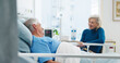 © peopleimages.com - Old couple, smile and conversation by hospital bed for support, compassion or empathy for recovery. Married, elderly people and happy in medical clinic with care, chat or good news for health update.