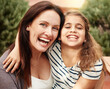 © Laflor2000/peopleimages.com - Portrait, mother and kid outdoor with hug, connection and love for bonding together on weekend break. Happy, mom and daughter with embrace, kindness and support for child development on vacation.