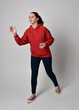 © faestock - full length figure of female model wearing  basic contemporary casual clothing, red hoodie jumper, skinny jeans, sneakers. walking action pose, isolated white studio background.