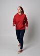 © faestock - full length figure of female model wearing  basic contemporary casual clothing, red hoodie jumper, skinny jeans, sneakers. walking action pose, isolated white studio background.