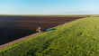 © Павел Чигирь - A tractor in a field with a seeder in spring, aerial view