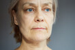 © evafesenuk - Close-up portrait of a mature woman with a calm confident expression.