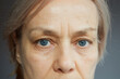 © evafesenuk - Close-up portrait of a mature woman with a calm confident expression.