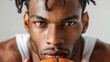 © Songsak - close-up basketball player with clenched jaw, intense look, white background