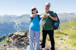 © Elena Medoks - Hikers gesturing thumbs up sign enjoying scenic mountain view