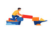 © Alan - Building a structure using colorful blocks on a blue surface while a person balances on a rock platform