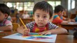 © LimeSky - Small Asian toddler drawing with colored pencils at school