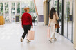 © Nataliya - Two girls with shopping bags are walking in a shopping mall.