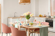 © Pixel-Shot - Modern interior of stylish kitchen with Easter table setting, counters and vase of flowers