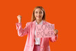 © Pixel-Shot - Mature business lady holding paper with text WOMAN POWER on red background
