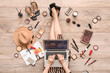 © Pixel-Shot - Woman with laptop, makeup products and accessories shopping online on light wooden floor