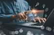 © sorapop - Online education, digital learning, and gaining knowledge are highlighted as person uses notebook to learn with e-learning icons, showing an online course video player on screen for modern students