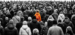 © Amelia Margaret - A lone woman in an orange jacket and backpack stands out in a crowd of people moving in the same direction walking movement group gathering many individuals mass humanity