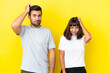 © luismolinero - Young couple isolated on yellow background with an expression of frustration and not understanding