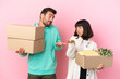 © luismolinero - young beauty couple moving in new home among boxes isolated on pink background making unimportant gesture while lifting the shoulders