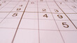 © helivideo - CLOSE UP, BOKEH: Detailed view of grid and numbers in sudoku number puzzle