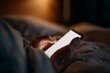 © maria_lh - Hands holding smartphone with blank white screen in bed at night. Person using mobile phone in dark bedroom. Mockup space