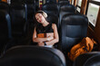 © Parichat - Young woman sleeping peacefully while traveling on a bus