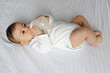 © SISMIZ - Baby Lying on Bed Drinking Milk from Bottle