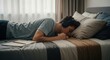 © Running opossum - young person listening to music with headphones while lying on bed in cozy bedroom
