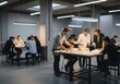© Alper - Diverse team collaborating on a project in a modern, open-plan office space
