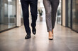 © pattozher - Business Stroll: Two professionals navigate a modern office corridor, showcasing the pace of modern business and the daily commute.
