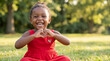 © Jian - National Wear Red Day African American girl making heart gesture for cardiovascular health awareness campaign poster website banner and magazine editorial content