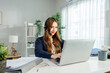 © Kawee - Asian young businesswoman working online from home in living room.