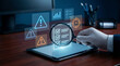 © Ishan - Auditor hand holding magnifying glass over virtual checklist and warning signs to conduct risk assessment and quality control inspection for compliance safety