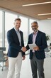 © Generative AI - Successful Partnership: Two Businessmen Shaking Hands in a Modern Office, Showing Collaboration and Agreement