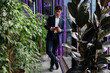 © Westend61 - Businessman using smartphone in modern office with plants and purple lights
